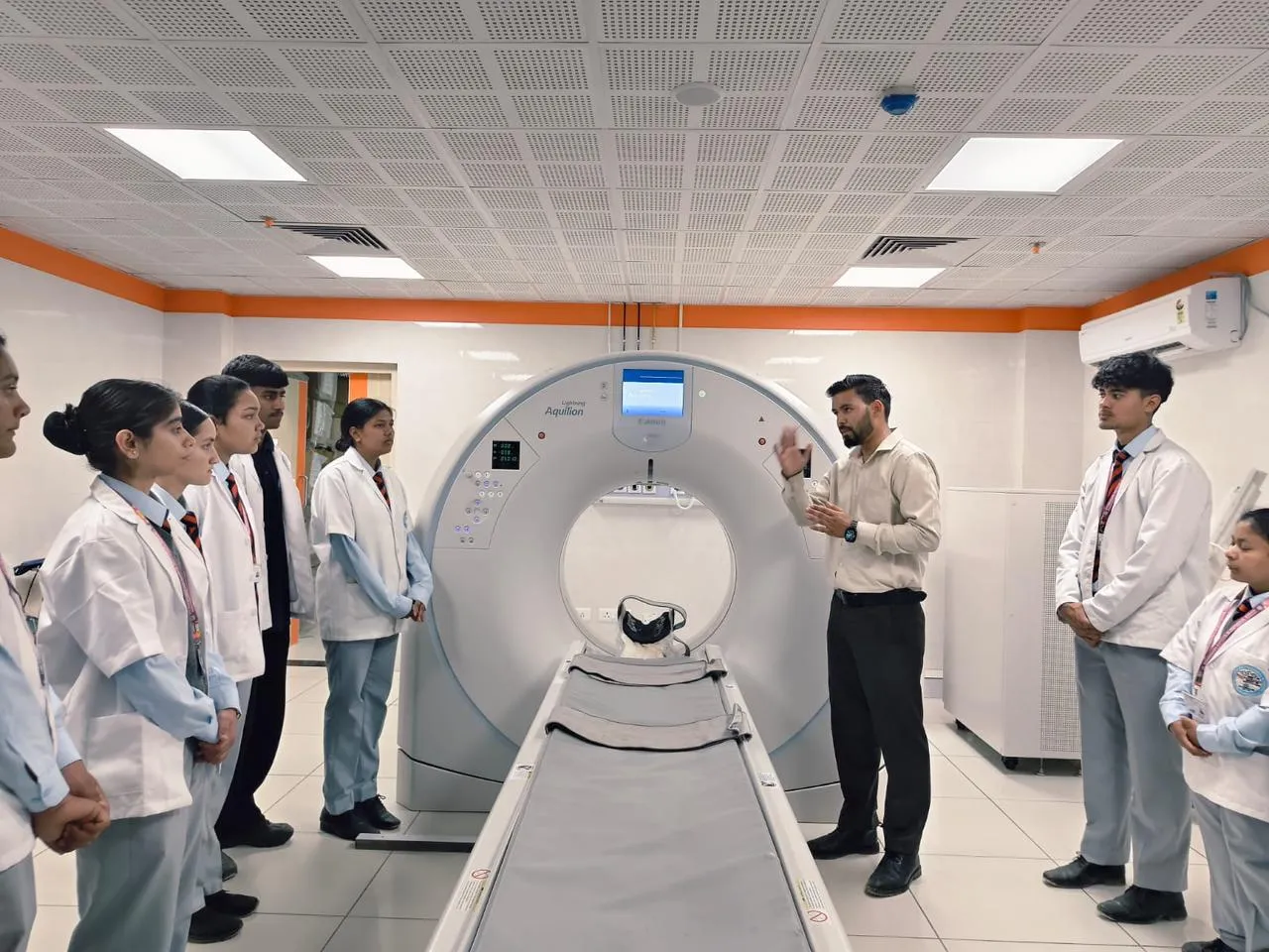 BMRIT students at the CT scanner during a practical session